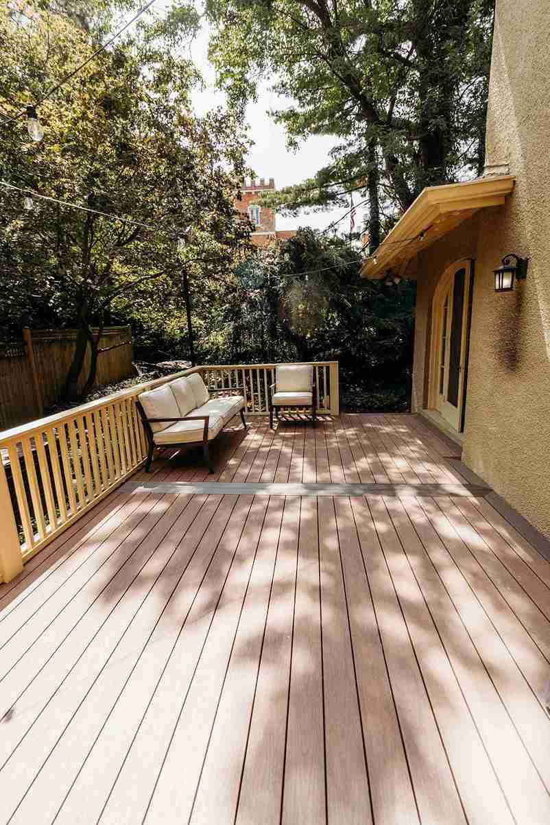 Beautifully crafted deck construction and installation project featuring composite decking, coordinated railings, and outdoor furnishings.